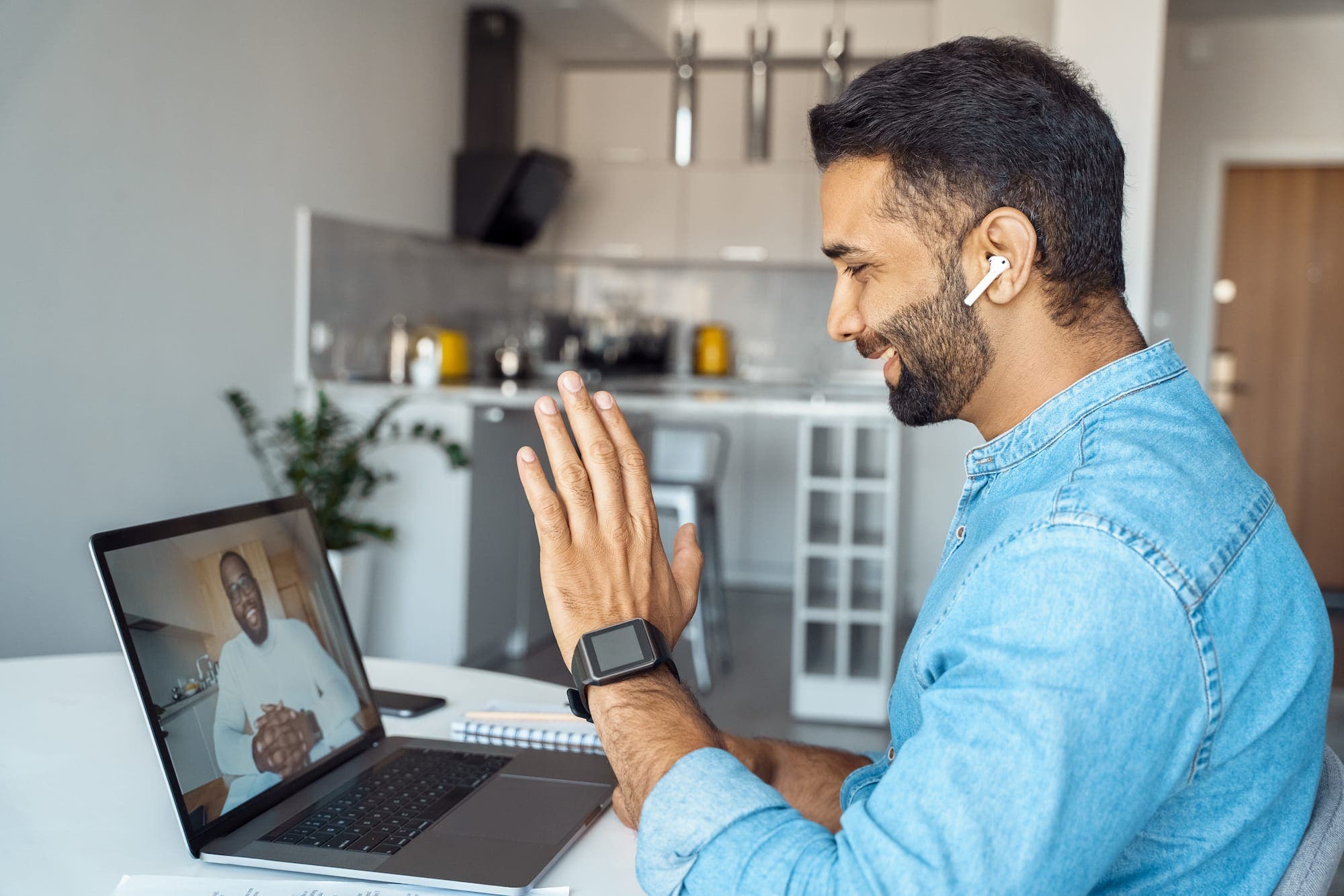 Man looking at his laptop talking to a fertility advisor over Zoom